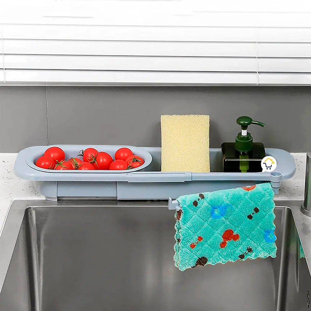 Escurridor plegable telescópico para cocina con tomates, esponja y dispensador de jabón.
