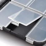 Estuche de pesca con compartimentos de plástico transparente y tapa dura.