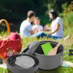 Kit de cocina portátil de camping con olla, sartén y accesorios, ideal para picnic familiar al aire libre.