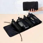 Organizador viajero negro con 4 cartucheras plegables, portátil y expandible, ideal para cosméticos.