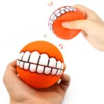 Pelota para perros de juguete con forma de sonrisa, naranja, con diseño divertido y sonido, ideal para juegos.