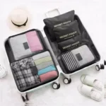 Organizador de maleta X6: bolsos de viaje con ropa doblada, sombrero y pantuflas a juego.
