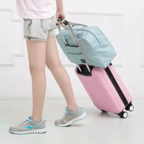 Maleta plegable impermeable azul, bolso de mano ligero, para viaje, tirando de maleta rosa.