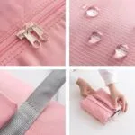 Maleta de viaje plegable e impermeable rosa con cremalleras y correa, ideal para equipaje de mano.