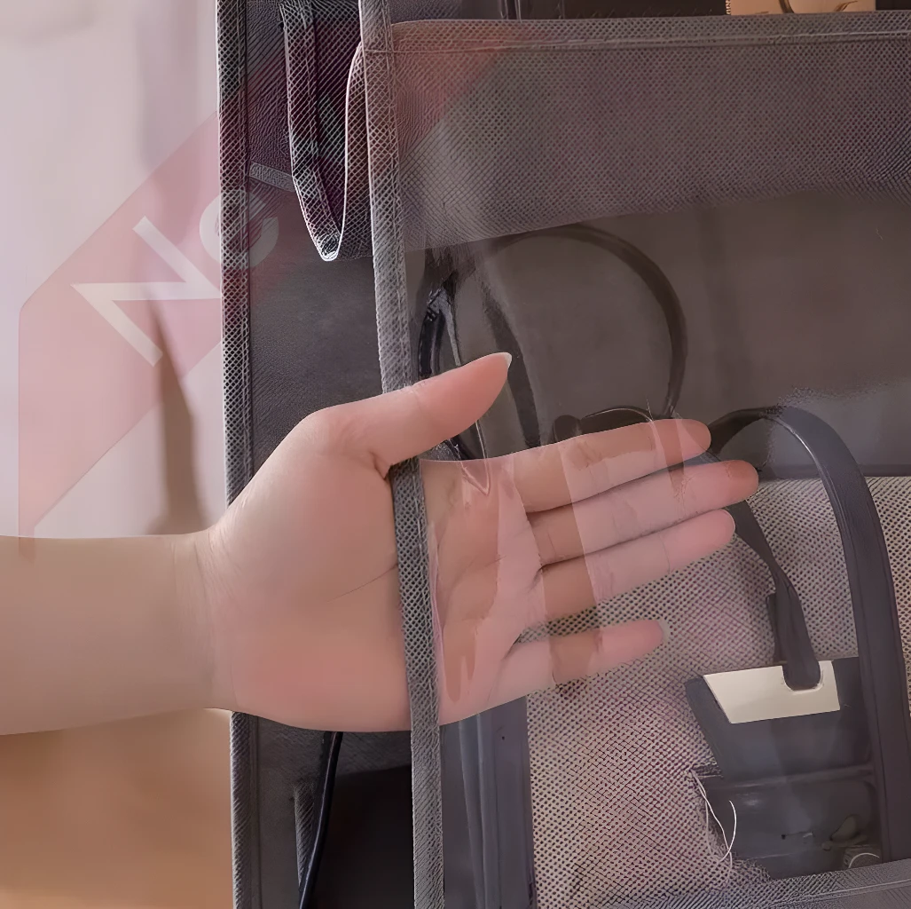 Organizador de bolsos de 4 niveles para armario, con mano que muestra la transparencia frontal.