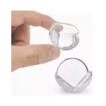 Esquineros de silicona transparentes para proteger bebés de muebles, sostenidos por un dedo.