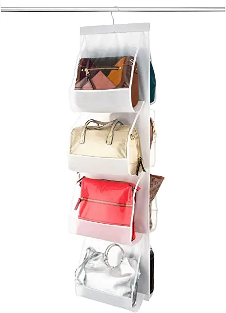 Porta bolsos colgante blanco con 4 compartimentos, exhibe bolsos de diferentes estilos y colores.