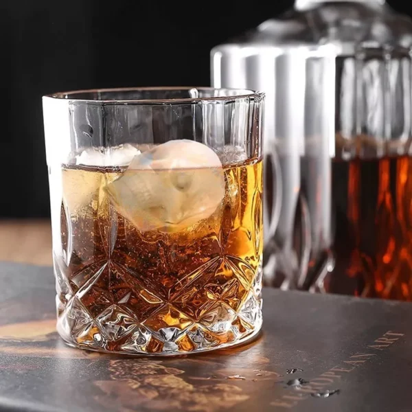 Molde Calavera Hielera Drop: vaso de whisky con hielo con forma de calavera y licor ámbar.