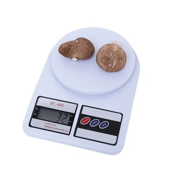 Gramera digital blanca con dos champiñones shiitake encima, mostrando 32 gramos.