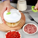 Picador manual de alimentos con resorte, ideal para picar ajo, chile y carne.