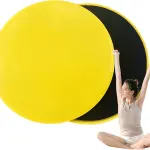 Discos deslizadores amarillos para yoga, par con mujer sentada en posición de loto.