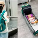 Bolso pañalera verde con cuna portátil para bebé, práctico para viajes.