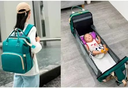 Bolso pañalera verde con cuna portátil para bebé, práctico para viajes.