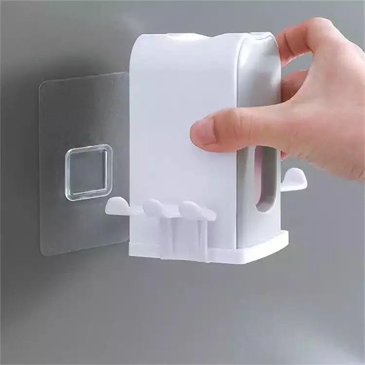 Soporte doble para cepillos de dientes con dispensador de pasta, fijado a la pared.