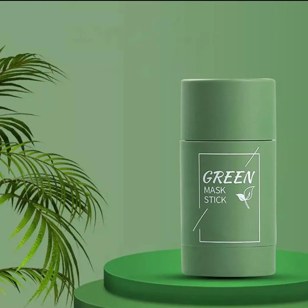 Green Mask Stick con hojas verdes sobre fondo verde y plataforma redonda.