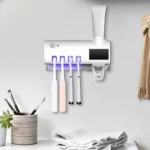 Soporte esterilizador UV para cepillos de dientes, con dispensador de pasta dental automático.
