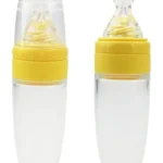 Cuchara biberón amarilla para papillas de bebé, ideal para alimentación infantil.