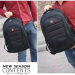 Morral casual negro para hombre, diseño moderno con detalles rojos y logo de marca.