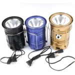 Lámpara solar Sh-5800T negra, azul y dorada con cables de carga.