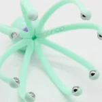 Masajeador de cabeza y cuello verde con tentáculos y esferas metálicas, ideal para alivio.