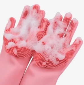 Guante esponja de silicona rosa con espuma para lavar loza en las manos.