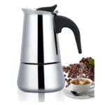 Cafetera italiana de expresso plateada para 9 tazas con taza de café humeante y granos de café.