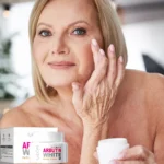 Mujer mayor aplicándose crema facial aclarante Arbutin Sadoer en el rostro para mejorar la apariencia.