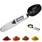 Cuchara gramera digital plateada con pantalla LCD y diferentes especias en montoncitos.
