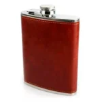 Licorera Whiskera de 8 oz forrada en cuero, con tapa metálica y costura decorativa.