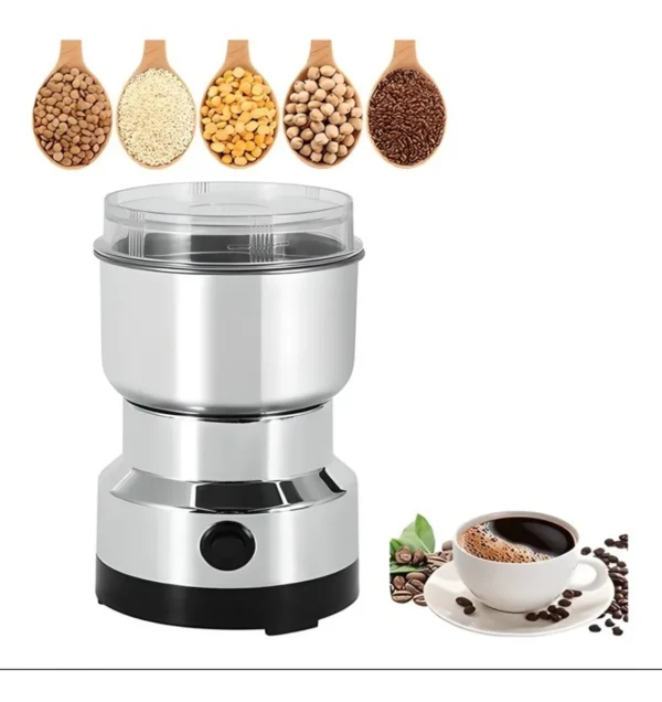 Molino de café eléctrico plateado junto a taza de café, granos y cucharas con ingredientes.