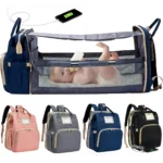 Bolso pañalera convertible en cuna para bebé, con cargador USB integrado y múltiples compartimentos.