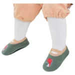 Caminadores Mis Primeros Pasos con diseño de dinosaurio verde para bebé.