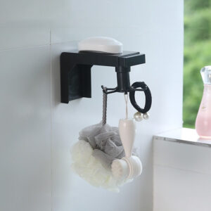 Organizador giratorio negro para baño con jabón, esponja y cepillo facial.