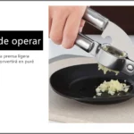 Prensa de ajo metálica fácil de usar aplasta ajo en puré finamente sobre plato negro.