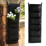 Bolsa vertical para plantar de fieltro negro con 6 bolsillos, ideal para colgar en exteriores.