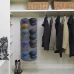 Organizador de gorras perchero de 14 puestos colgado en closet, ideal para almacenar cachuchas.