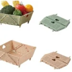 Canasta plegable de almacenamiento beige y verde, ideal para organizar frutas y verduras en la cocina.