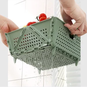 Canasta plegable verde con asas para almacenar y escurrir frutas y verduras.