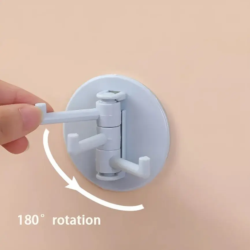 Gancho adhesivo giratorio con 3 brazos, ideal para colgar objetos con rotación de 180°.