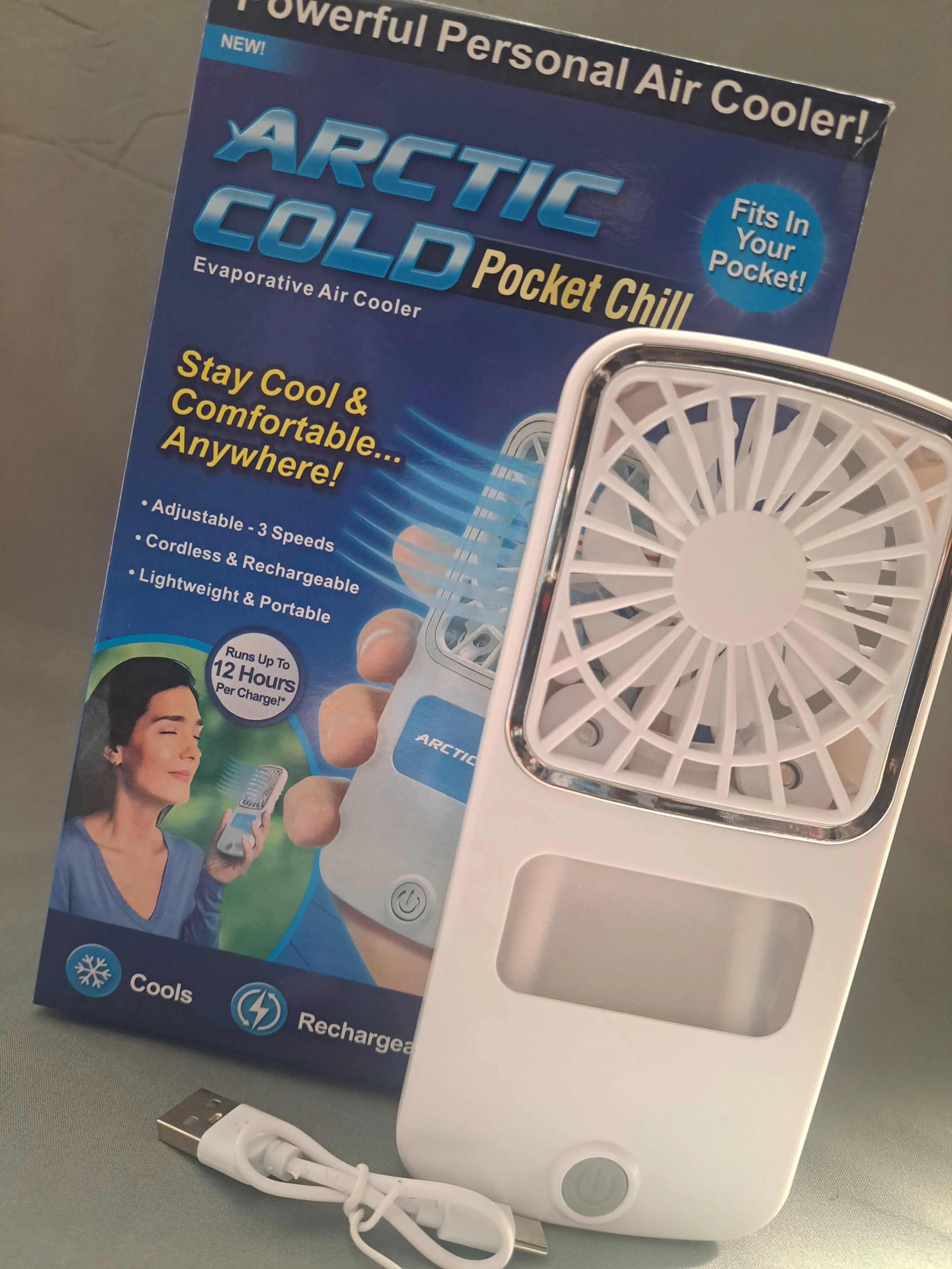 Ventilador de mano recargable Arctic Cold Pocket Chill con cable USB y detalles en empaque.
