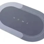 Tapete antideslizante y absorbente "HOME" gris ovalado, ideal para baños y cocinas.