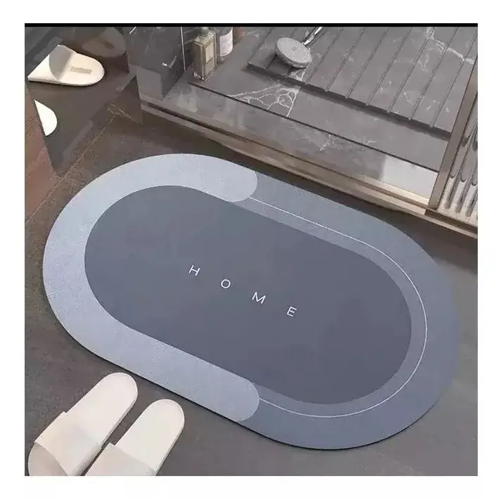 Tapete antideslizante y absorbente con la palabra "HOME" en gris.