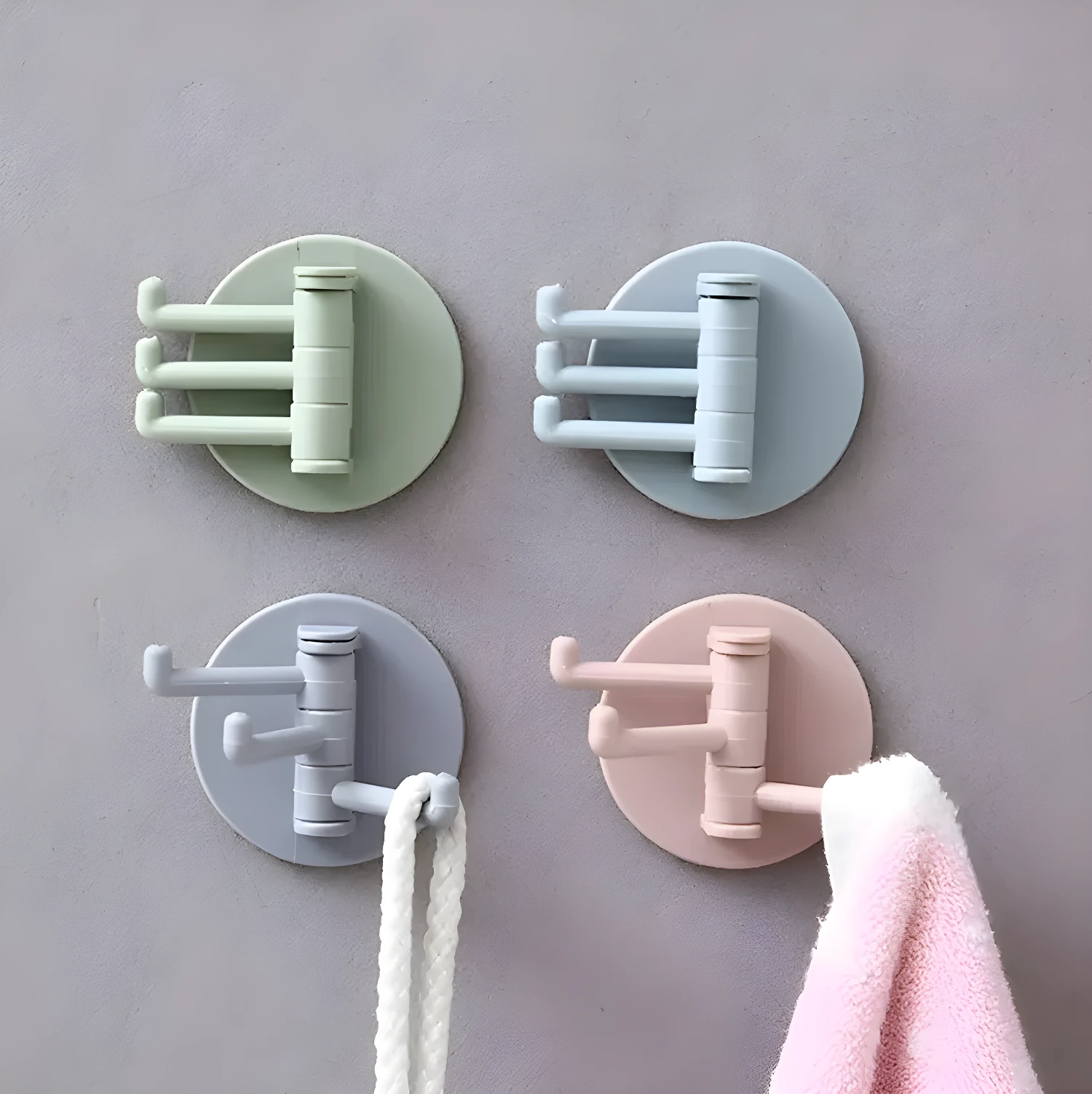 Gancho adhesivo giratorio x3 color menta, azul, gris y rosa, ideal para colgar toallas y objetos.