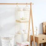 Colgador de ropa de 3 niveles con textiles beige en armario de madera.