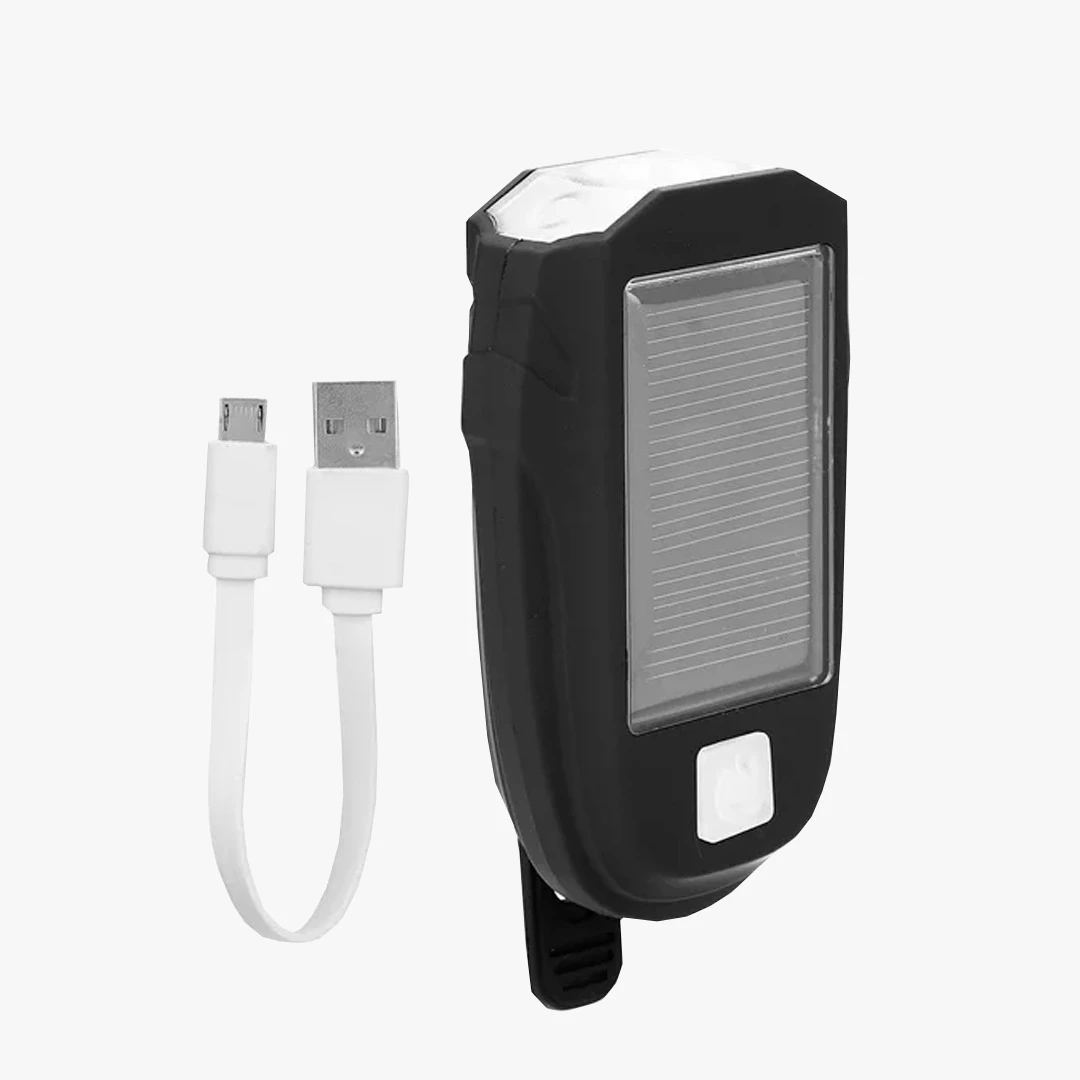 Luz frontal para bicicleta con panel solar y carga USB, diseño compacto.