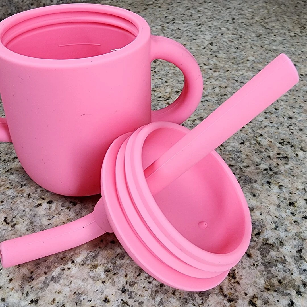 Vaso entrenador de silicona rosa para bebé con sorbete y tapa, superficie texturizada