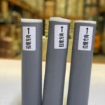 Tres fundas de silicona grises para ollas, con etiquetas de dirección de estiramiento.