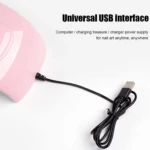 Lámpara de uñas 48W rosa con conexión USB, ideal para manicura.