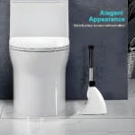 Escobilla de baño magnética blanca con diseño elegante al lado de un inodoro moderno.