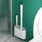 Escobilla de silicona para baño con soporte, diseño moderno en verde y blanco.